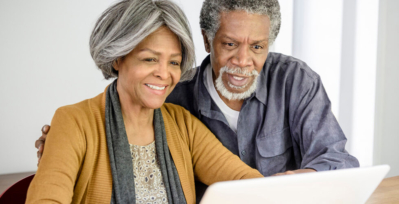 Elderly couple looking at a laptop