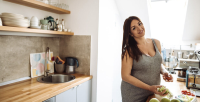 Plus-size pregnant woman in kitchen