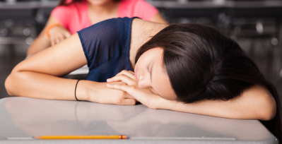Girl sleeping at school desk