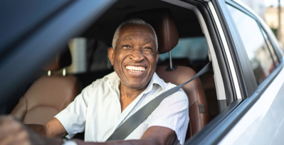 Older male driving a car