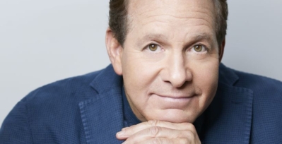 Headshot of Steve Guttenberg.